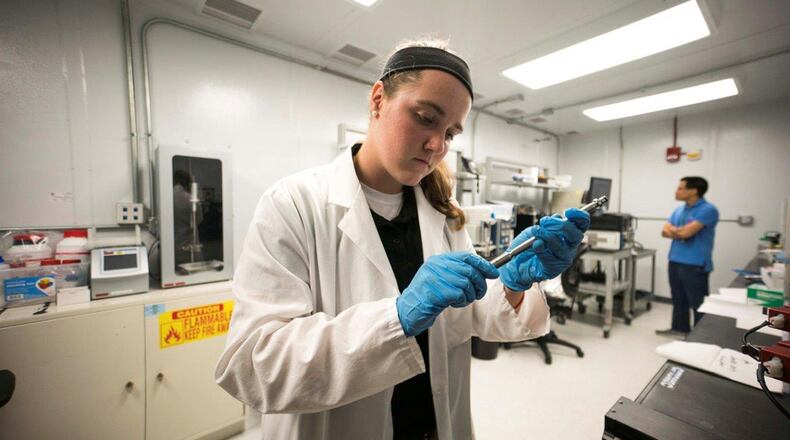 Leadership, Experience, Growing, Apprenticeships Committed to Youth Apprentice Bri Ewing, a Catholic Central High School senior, prepares for an experiment in a clean room at the Air Force Research Laboratory’s Aerospace Systems Directorate in summer 2017. LEGACY is a free science, technology, engineering and math program sponsored by the Air Force Research Laboratory available to students in the sixth grade through college. (Courtesy photo)