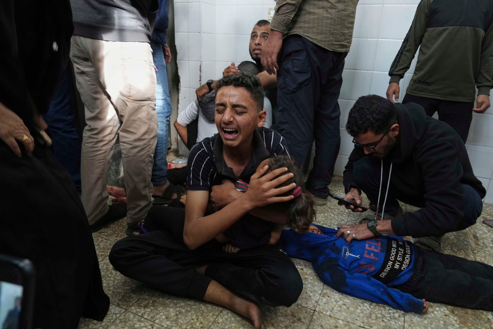 Samy Abed, center, mourns his sister Massa Abed, 4, who was killed in an Israeli army airstrike on the Gaza Strip, at the morgue of Al-Aqsa Hospital in Deir al-Balah, Gaza, Sunday, April 27, 2025. (AP Photo/Abdel Kareem Hana)