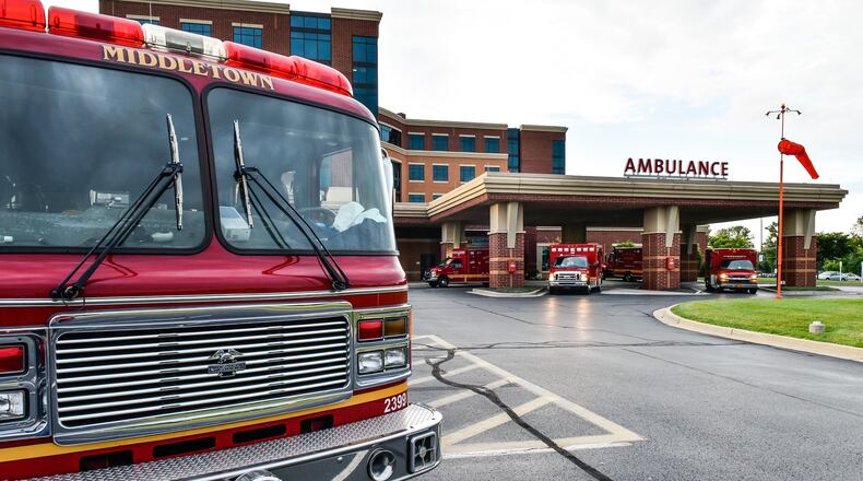 Four medic units and a fire engine from Middletown Division of Fire are parked at the emergency room entrance at Atrium Medical Center after the there were four emergency calls in the city within minutes Monday, June 26. NICK GRAHAM/STAFF