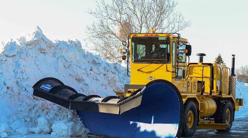 A plow operator with the 88th Civil Engineer Squadron pushes snow into a huge pile Feb. 23 on the airfield at Wright-Patterson Air Force Base. From November to April, the snow-removal team runs 24-hour operations with as many as 30 pieces of equipment to make sure the base mission can continue. (U.S. Air Force photo by Wesley Farnsworth)