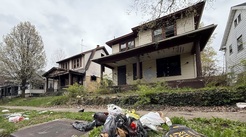 A couple of vacant homes on the first block of Pointview Avenue in Dayton's North Riverdale neighborhood. A teen was shot in a vacant home on this block last year during a drug deal. CORNELIUS FROLIK / STAFF