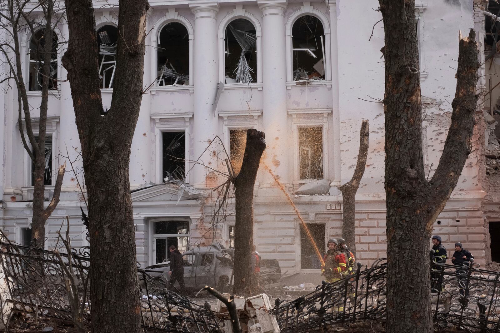 A rescue worker puts out a fire from a tree after a Russian missile strike on Sumy, Ukraine, Sunday, April 13, 2025. (AP Photo/Volodymyr Hordiienko)