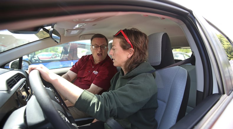 In this Tuesday, June 13, 2017, photo, vehicle shopper Mary Jean Jones takes a test drive in a Prius C Hybrid with Mark Miller Toyota salesman Doug Lund in Salt Lake City. When people go car shopping, they usually focus on the vehicle they want, not the loan that will pay for it. But good financing is the bedrock of a solid car deal, and missteps could cost you thousands. (AP Photo/Rick Bowmer)