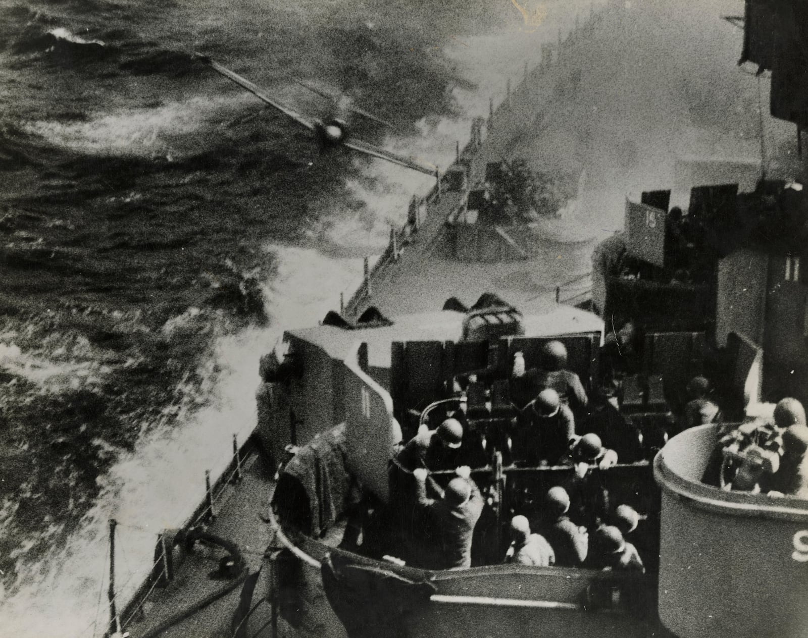 This image provided by the U.S. National Archives shows a scan of a photo of a Japanese Zero fighter plane hitting the USS Missouri in waters off Okinawa, Japan on April 11, 1945. (U.S. National Archives photo no. 80-G-315811A via AP)