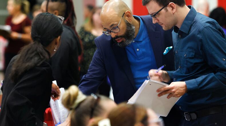David Lawernce, left, with the City of Dayton talks with Johann Nielsen-Sperb Wednesday, Sept. 18, 2024 at the Montgomery County Workforce Development Fall Job Fair at the Dayton Convention Center. Job seekers had the opportunity to meet with over 100 local employers and explore a variety of jobs. MARSHALL GORBY\STAFF