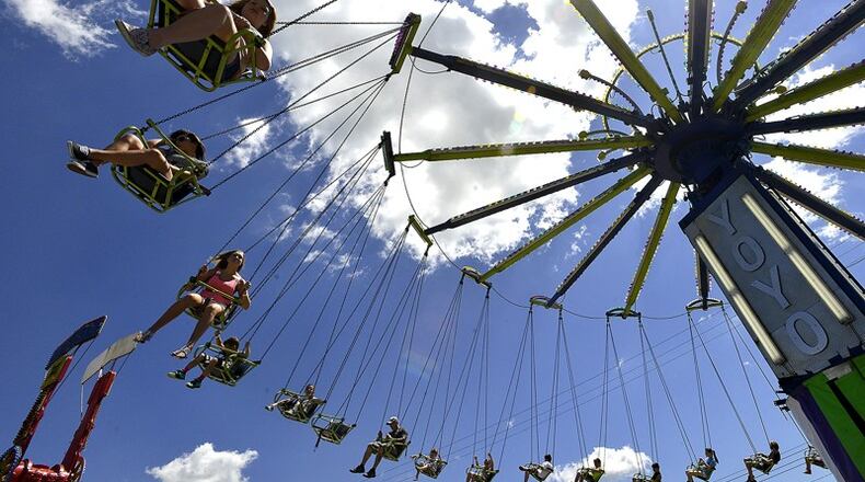 Clark County Fair goers ride the swings on the midway under a beautiful sky Friday. BILL LACKEY/STAFF