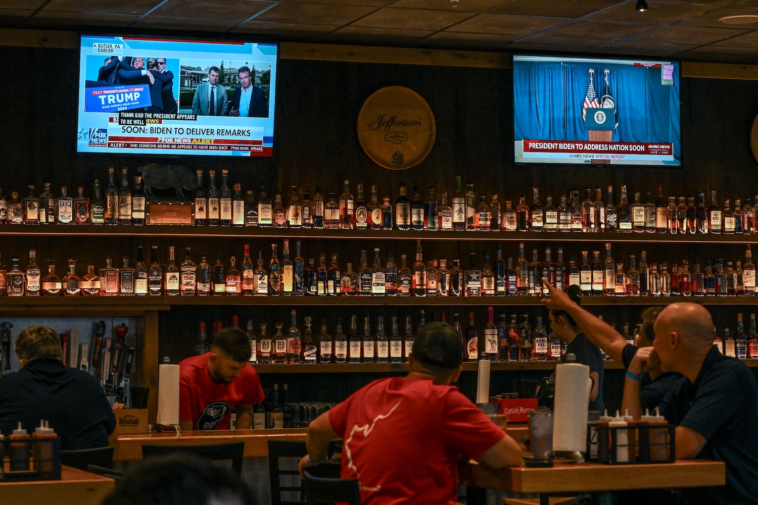 Patrons at a restaurant in Milwaukee watch the news of the attempted assassination of former President Donald Trump, Saturday, July 13, 2024. (Doug Mills/The New York Times)