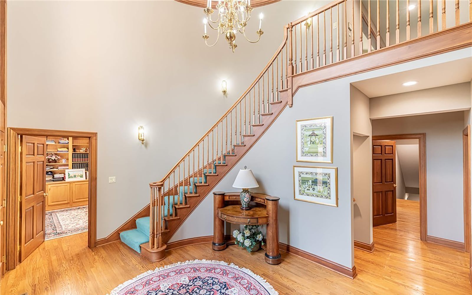 The two story foyer has hardwood flooring and a wood spiral staircase to the second level.