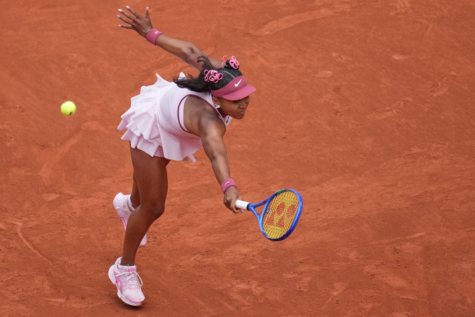 Japan's Naomi Osaka returns the ball to Spain's Paula Badosa during their first round match of the French Tennis Open, at the Roland-Garros stadium, in Paris, Monday, May 26, 2025. (AP Photo/Christophe Ena)