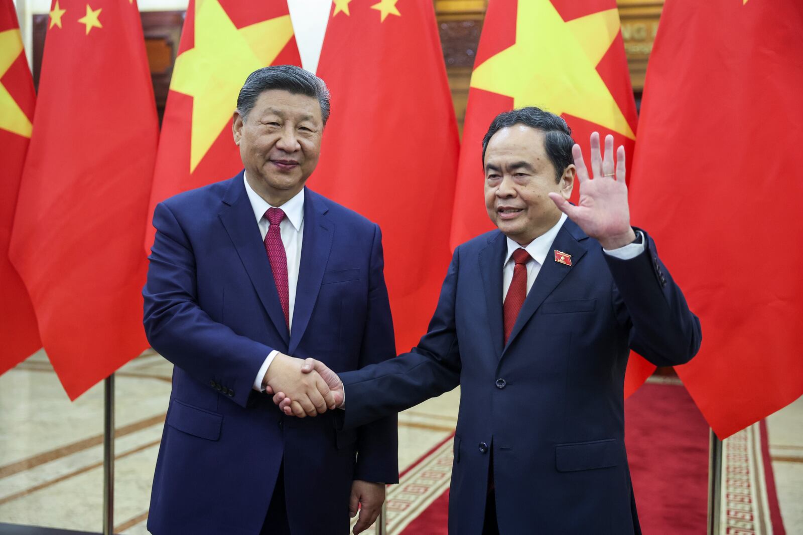 Chinese President Xi Jinping, left, shakes hands with Vietnam's National Assembly Chairman Tran Thanh Man, in Hanoi, Vietnam, Monday April 14, 2025. (Athit Perawongmetha/Pool Photo via AP)