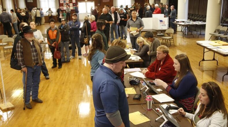 Voters at Community Golf Course in Kettering were met with a long line inside the polling place. Most voters reported waiting at least one hour to cast their ballots around noon. (Ty Greenlees/Staff)