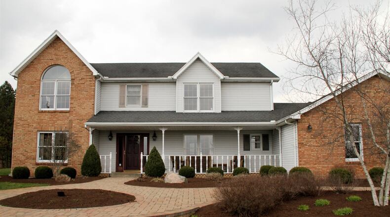 The brick-and-vinyl, 2-story home sits on 2 acres overlooking the valley. The 3-car garage has textured flooring. CONTRIBUTED PHOTOS BY KATHY TYLER