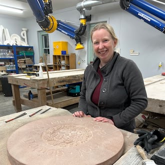 Jennie Regan stands beside the stone she carved with an inscription from a Scottish fairy tale at Dumfries House in Cumnock, Scotland, Nov. 26, 2025. (AP Photo/Danica Kirka)