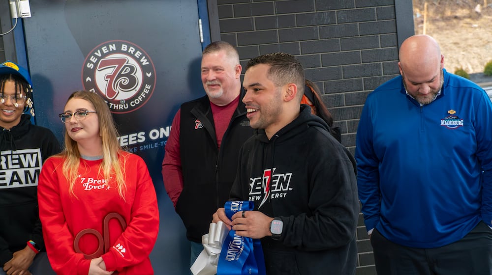 Chace Baxter, 7 Brew Coffee regional manager, welcomes attendees to the ribbon-cutting ceremony held at the new 7 Brew Coffee location at at 310 N. Springboro Pike, which was held March 3 in collaboration with the Dayton Chamber of Commerce. CONTRIBUTED