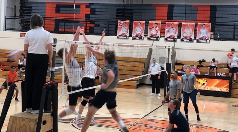 A Fairmont player spikes the ball past two Beavercreek blockers during their volleyball match April 4, 2019. CONTRIBUTED