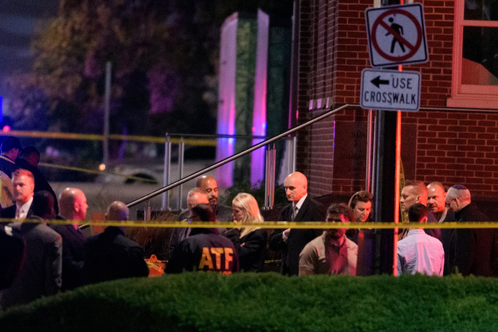 Attorney General Pam Bondi, center, walks to her car as law enforcement work the scene after two staff members of the Israeli Embassy in Washington were shot and killed outside the Capital Jewish Museum, Thursday, May 22, 2025, in Washington. (AP Photo/Rod Lamkey, Jr.)