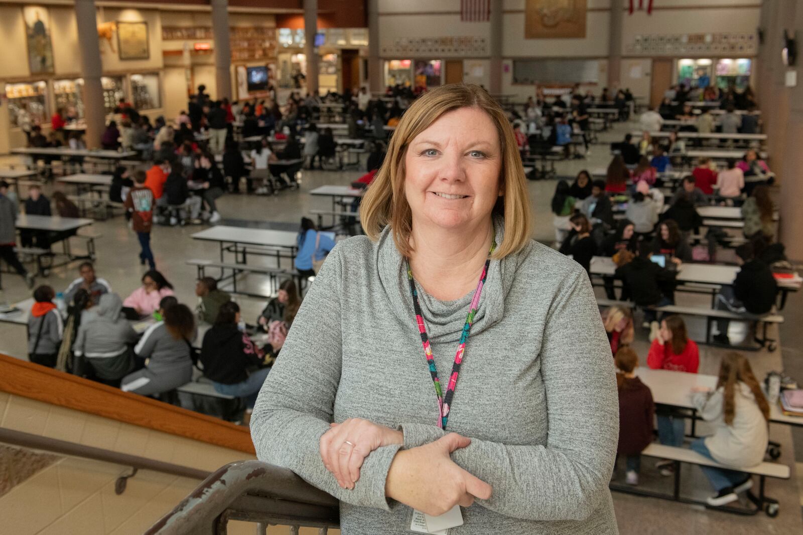Mansfield Senior High School attendance coordinator Kari Cawrse stands with the school cafeteria in the background in Mansfield, Ohio, Friday, Dec. 6, 2024. (AP Photo/Phil Long)