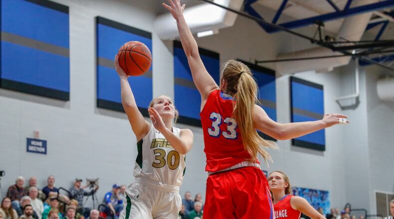 Catholic Central sophomore Serenity Castle shoots the ball over Tri-Village’s Maddie Downing (33) during their district semifinal game on Monday night at Brookville High School. The Patriots won 62-32. CONTRIBUTED PHOTO BY MICHAEL COOPER