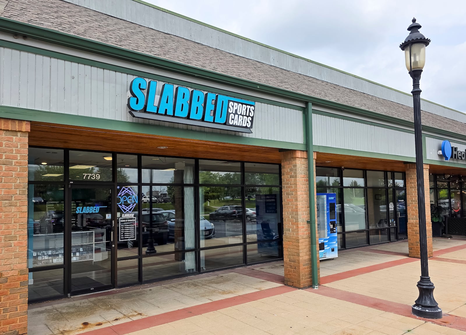 Slabbed Sports Cards on Tylers Place Blvd. in West Chester Township has a sports card vending machine outside to purchase card packs outside of normal operating hours. NICK GRAHAM/STAFF