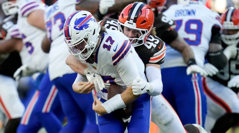 Buffalo Bills quarterback Josh Allen (17) is sacked by Cleveland Browns linebacker Carson Schwesinger (49) during the second half of an NFL football game in Cleveland, Sunday, Dec. 21, 2025. (AP Photo/Sue Ogrocki)