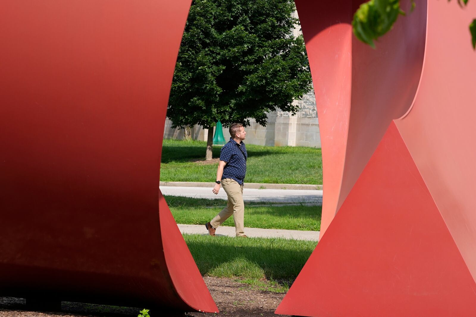 A guest walks on the campus of Indiana University, Thursday, July 17, 2025, in Bloomington, Ind. (AP Photo/Darron Cummings)