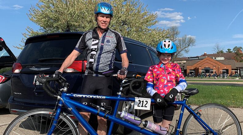 The youngest Blue Streak Time Trial rider in the season opener April 13 was 7-year-old Etta Hudson of Tipp City. Etta was the stoker on a tandem bicycle behind her grandfather, retired Lt. Gen. Jack Hudson. CONTRIBUTED PHOTO