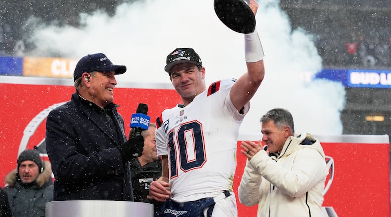 New England Patriots quarterback Drake Maye celebrates with the trophy after the AFC Championship NFL football game between the Denver Broncos and the New England Patriots, Sunday, Jan. 25, 2026, in Denver. (AP Photo/John Locher)