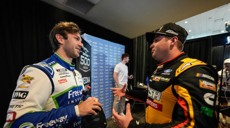 Corey LaJoie and Noah Gragson, from left, speak during a NASCAR Daytona 500 media day, Wednesday, Feb. 11, 2026, in Daytona, Fla. (AP Photo/Mike Stewart)