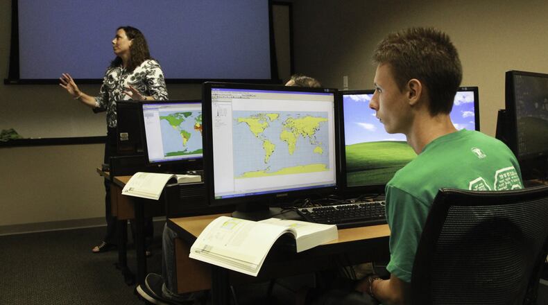 Jacob Holt of Xenia attends a Clark State Community College introduction to GIS and cartography class taught by Aimee Belanger-Haas, at left, in Beavercreek on Tuesday, September 10. CHRIS STEWART / STAFF
