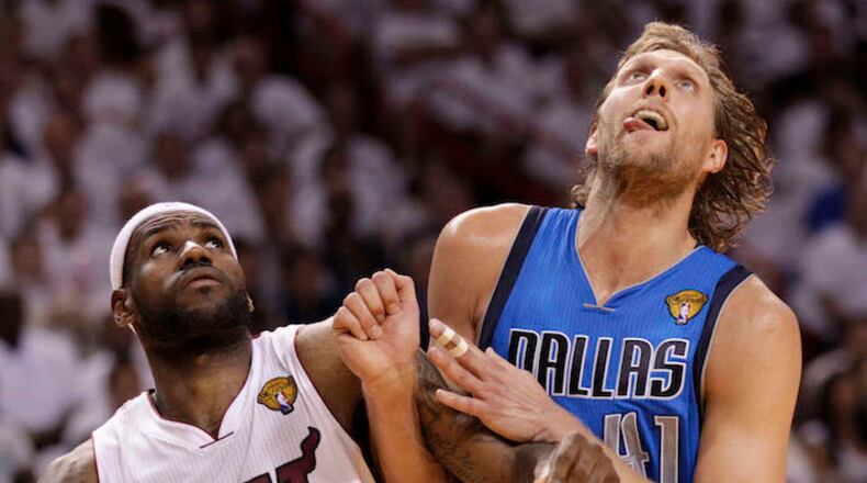 LeBron James, left, and Dirk Nowitzki jockey for position under the basket during Game 6 of the NBA Finals between the Miami Heat and the Dallas Mavericks at the AmericanAirlines Arena in Miami on June 12, 2011. (Al Diaz/Miami Herald/TNS)