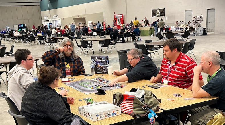 Attendees at AcadeCon 2023 play a board game at the Dayton Convention Center in November 2023. AcadeCon 2024 runs from Nov. 8 to 10, 2024. CONTRIBUTED