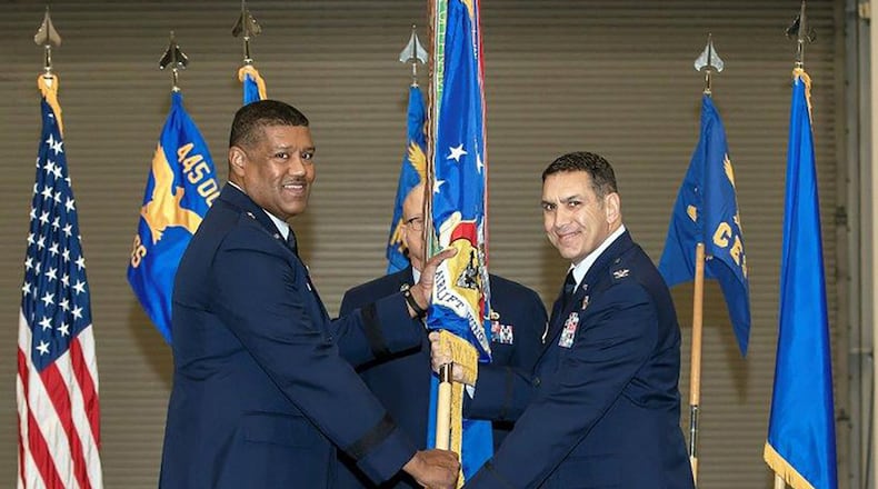 Col. Raymond Smith Jr. (right), incoming commander for the 445th Airlift Wing, takes the guidon from Brig. Gen. Robert Blake, mobilization assistant to the director of current operations, deputy chief of staff for operations, Headquarters U.S. Air Force, Washington D.C., during the wing’s assumption of command ceremony Jan. 4 at Wright-Patterson Air Force Base. (U.S. Air Force photos/Master Sgt. Patrick O’Reilly)