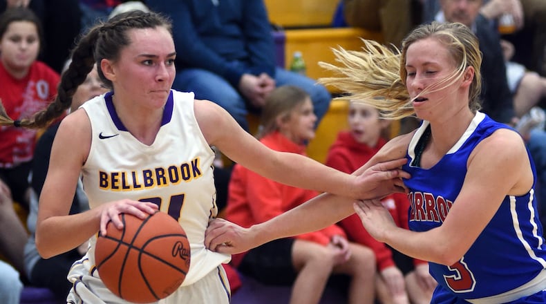 Bellbrook’s Cassidey Hofacker (left) is checked by Carroll’s Morgan King. NICK FALZERANO / CONTRIBUTED PHOTO