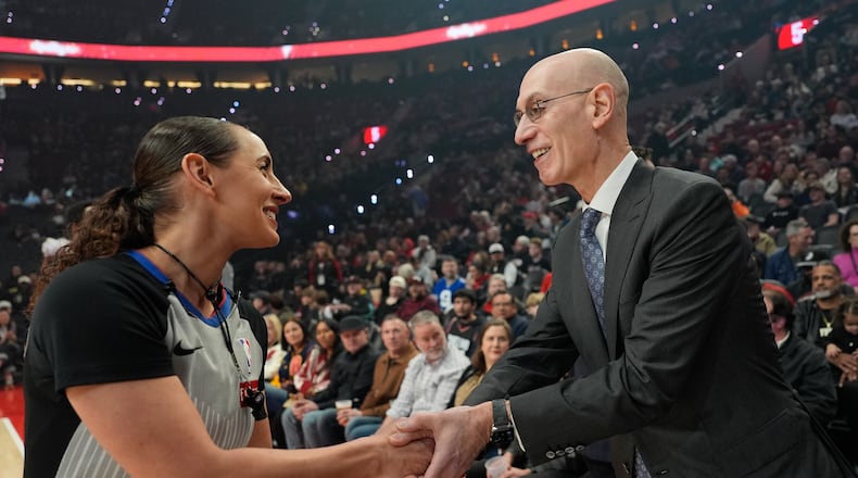 NBA commissioner Adam Silver greets NBA referee Ashley Moyer-Gleich as he arrives for an NBA basketball game between the Portland Trail Blazers and the Utah Jazz, Friday, March 13, 2026, in Portland, Ore. (AP Photo/Jenny Kane)
