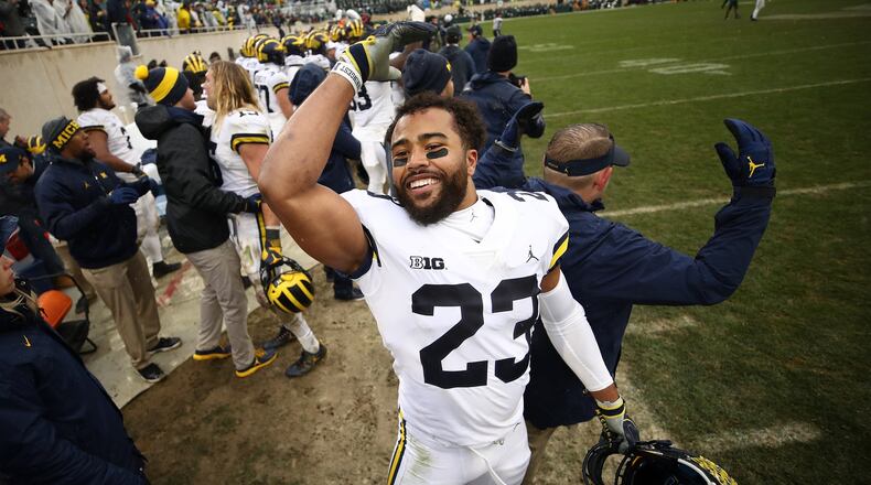 EAST LANSING, MI - OCTOBER 20: Tyree Kinnel #23 of the Michigan Wolverines celebrates on the sideline as the clock winded down on a 21-7 win over the Michigan State Spartans at Spartan Stadium on October 20, 2018 in East Lansing, Michigan. (Photo by Gregory Shamus/Getty Images)