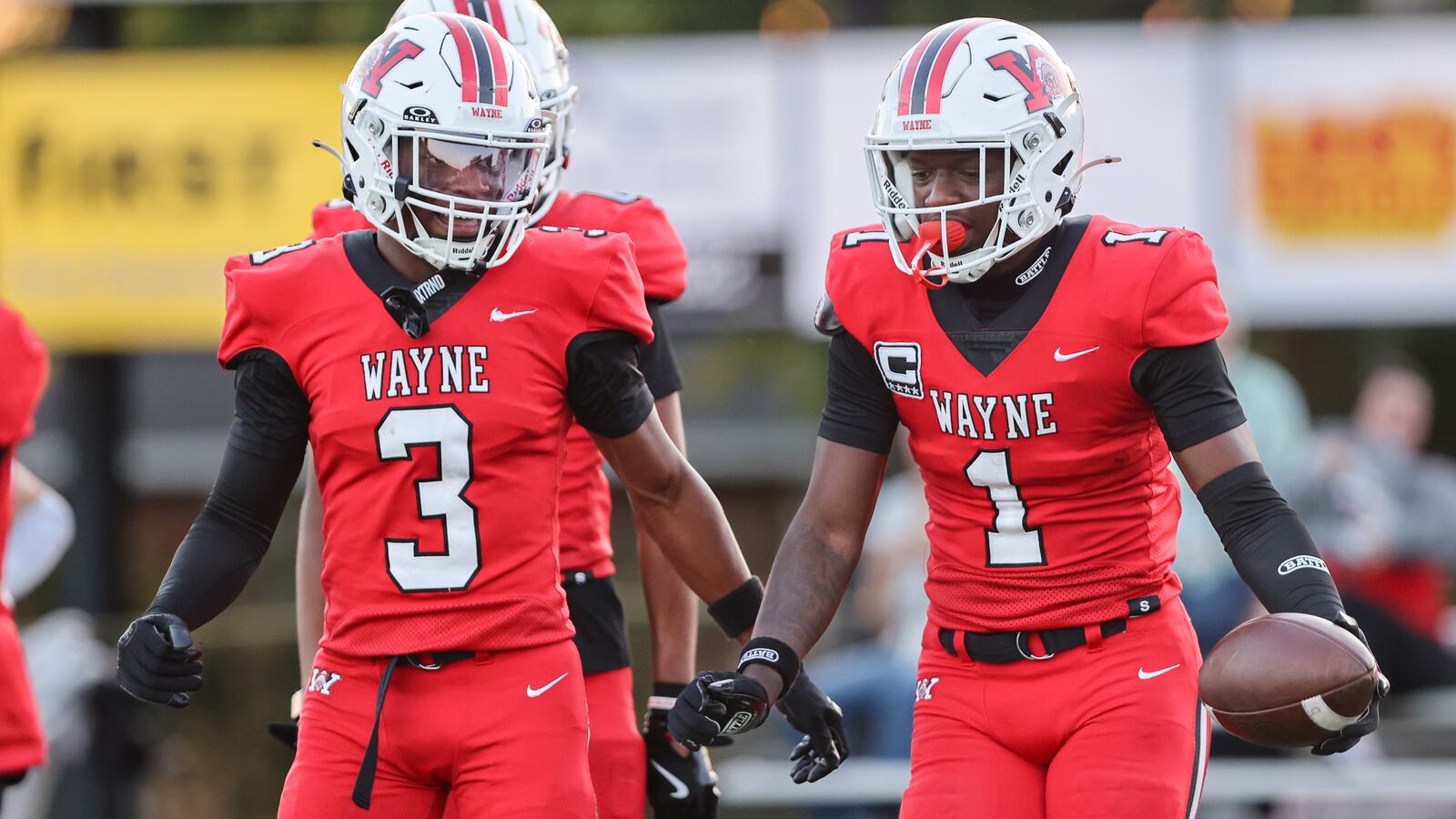Wayne senior receiver Jamier Averette-Brown (right) celebrates with senior receiver Semarion Sroufe (left) after Brown scored a touchdown in the first half of a Greater Western Ohio Conference game against Springboro on Friday, Sept. 12 at Heidkamp Stadium. Brown each had over 100 yards receiving and each scored two touchdowns in a 48-23 win. BRYANT BILLING / STAFF