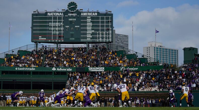 Fans watch the first half of an NCAA college football game between Iowa and Northwestern, Saturday, Nov. 4, 2023, at Wrigley Field in Chicago. (AP Photo/Erin Hooley)