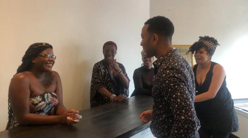John Legend makes a stop at Puff Apothecary in the Oregon District on Sunday, Aug. 11, one week after the mass shooting that killed nine people and injured 27 others. AMELIA ROBINSON/STAFF