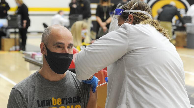 Oakwood schools Superintendent Kyle Ramey, receives his first dose of COVID-19 vaccine at Centerville High School, Wednesday, Feb. 3, 2021. MARSHALL GORBY\STAFF