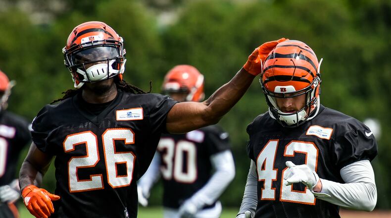 Bengals’ safety Josh Shaw (26) pats fellow safety Clayton Fejedelem on the helmet during organized team activities Tuesday, May 22 at the practice facility near Paul Brown Stadium in Cincinnati. NICK GRAHAM/STAFF