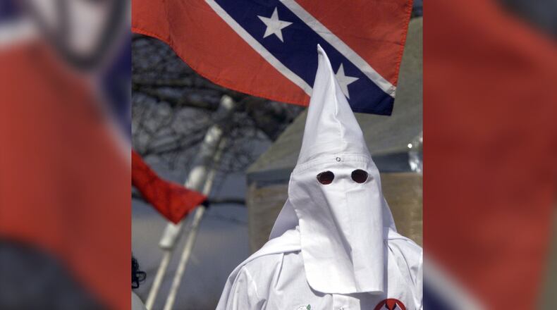 A Ku Klux Klan member stands on the stairs of the Kettering Government Center during a 2005 rally. FILE