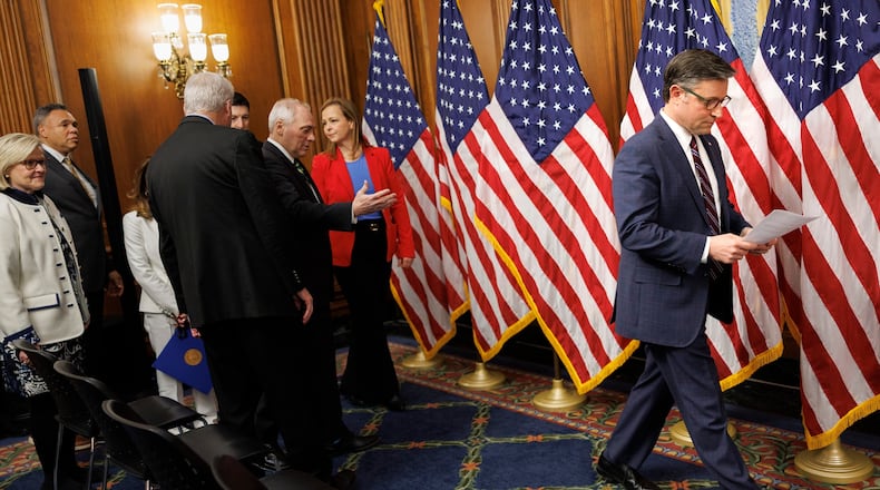 House Speaker Mike Johnson, R-La., reads notes before speaking about the SAVE America Act to reporters on Capitol Hill in Washington, Wednesday, Feb. 11, 2026, in Washington. (AP Photo/Tom Brenner)