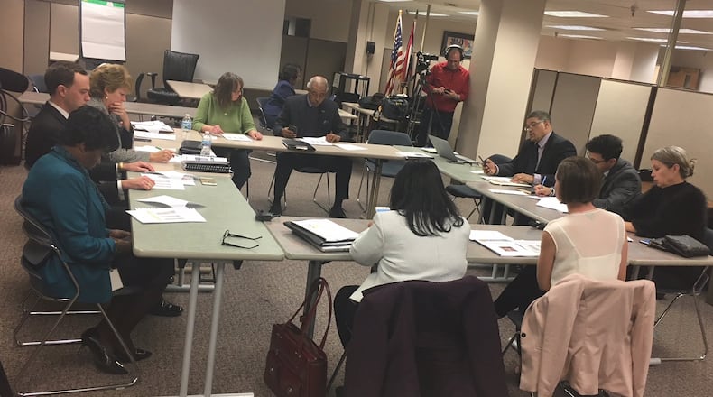 Current and future members of Dayton’s school board discuss leadership roles with district administrators during their Dec. 19, 2017 meeting. JEREMY P. KELLEY / STAFF