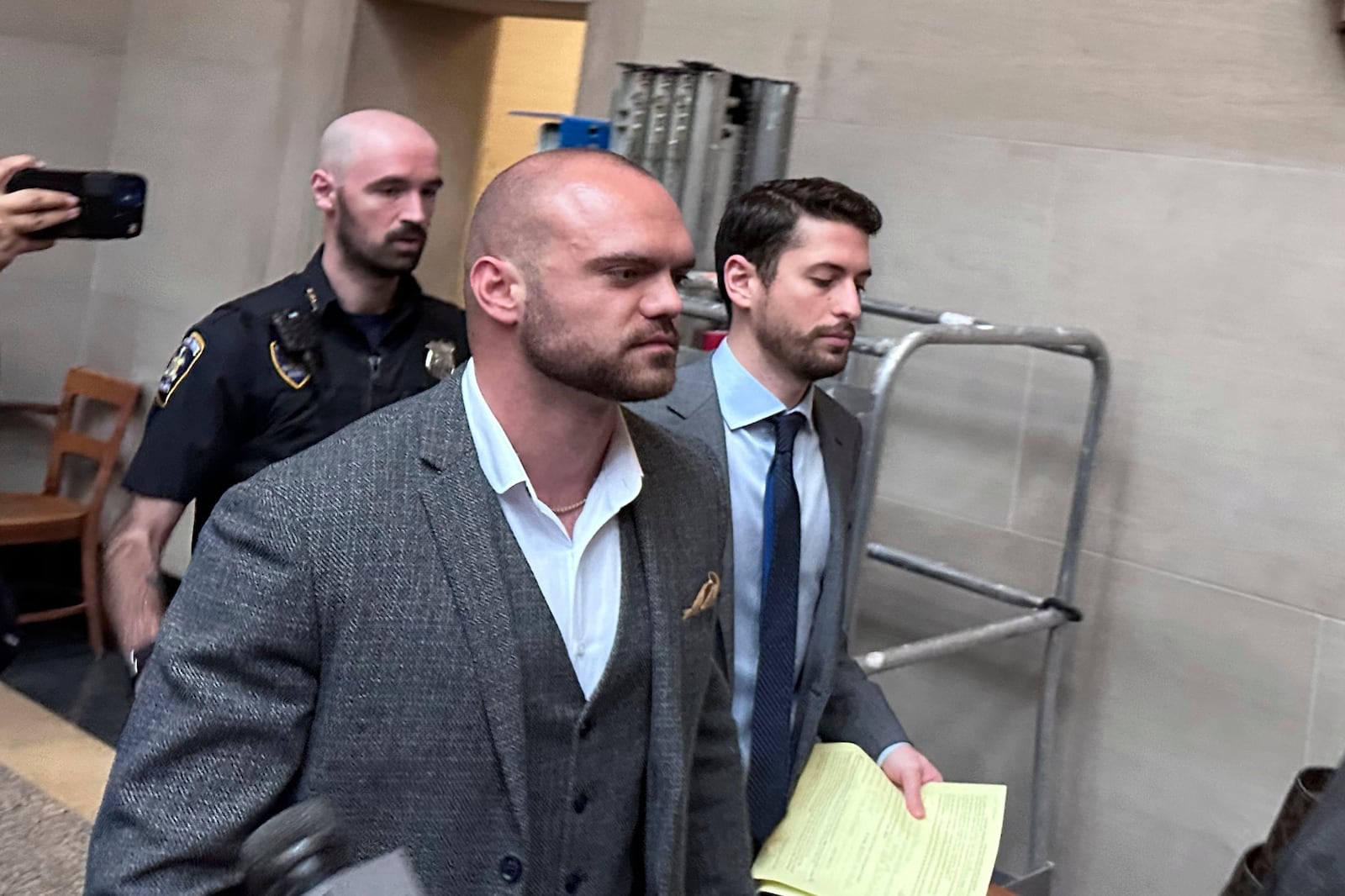 Former New York state trooper Thomas Mascia leaves Nassau County court in Mineola, N.Y. on Wednesday, May 21, 2025, after pleading guilty to charges that he shot himself and lied about it. (AP Photo/Philip Marcelo)