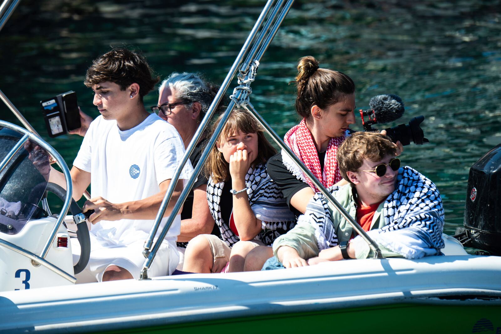 Climate activist Greta Thunberg, center, waits to board the Madleen boat, before setting sail for Gaza along with activists of the Freedom Flotilla Coalition, departing from the Sicilian port of Catania, Italy, Sunday, June 1, 2025. (AP Photo/Salvatore Cavalli)