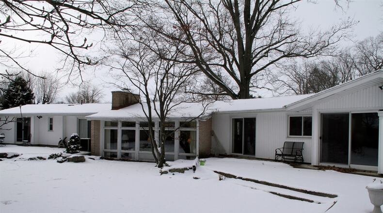Patio doors from the family room and 2 bedrooms open outside to a patio with landscaped surroundings.