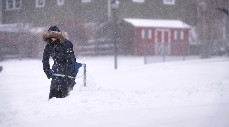 FILE - Maryann Slovin begins clearing out her driveway and sidewalk in Hockessin, Del., on Sunday, Jan. 25, 2026, as a snow storm moves through region. (AP Photo/Suchat Pederson, File)