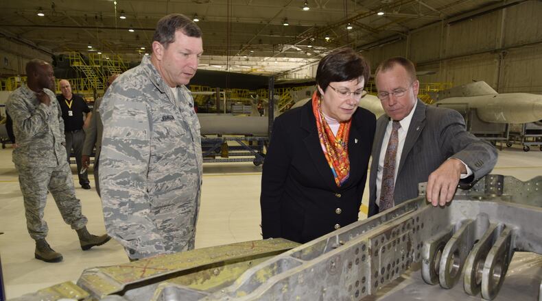 Retiring Air Force Materiel Command Executive Director Patricia Young (center) looks on as Jeffrey Allen, Air Force Sustainment Center executive director (right), points out splice-plates on a B-52 landing gear trunnion during a mission and capabilities tour Nov. 29, 2016, at Tinker Air Force Base, Okla.
(U.S. Air Force photo/Greg L. Davis)