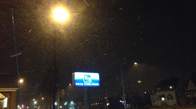 Snow showers fell early Wednesday morning along Patterson Road in Dayton. MIKE CAMPBELL/STAFF