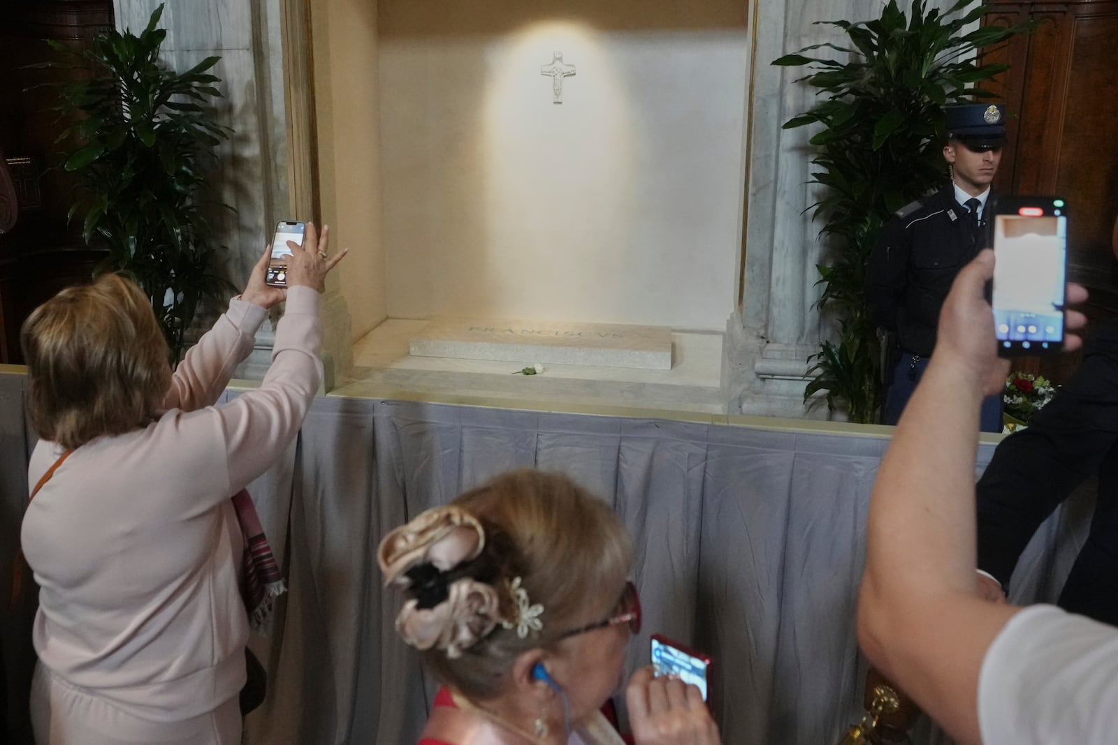 Faithful take images of the tomb of Pope Francis inside St. Mary Major Basilica in Rome, Sunday, April 27, 2025. (AP Photo/Alessandra Tarantino)